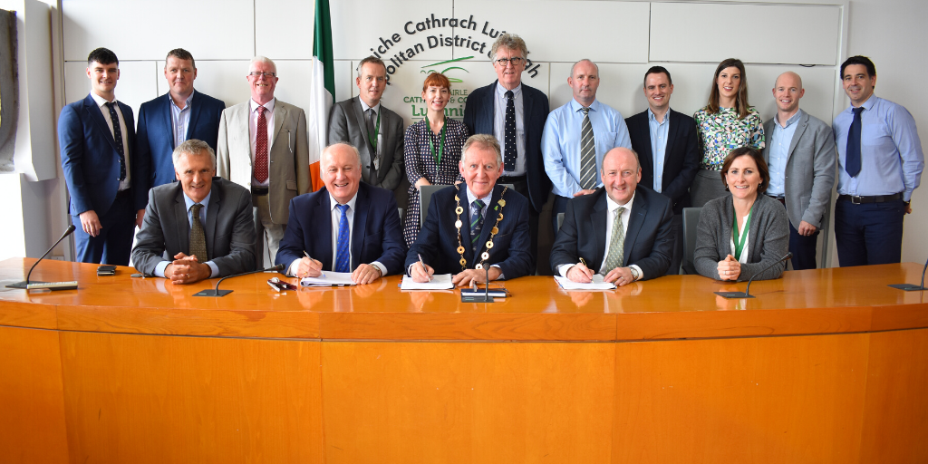 Glenman Corporation director Albert Conneally (front row second left) pictured with Mayor of Limerick Michael Sheahan at the signing of contracts for a new social housing development in Clonmacken, Limerick. Photo courtesy of Limerick City and County Council.